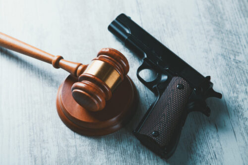 gun and judge's gavel