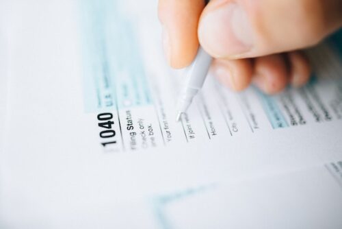 person filling in tax forms