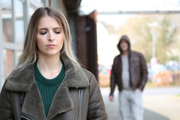 man stalking woman