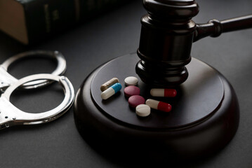 gavel handcuffs and pills