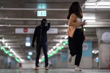 man pointing gun at woman