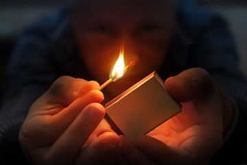 man lighting match