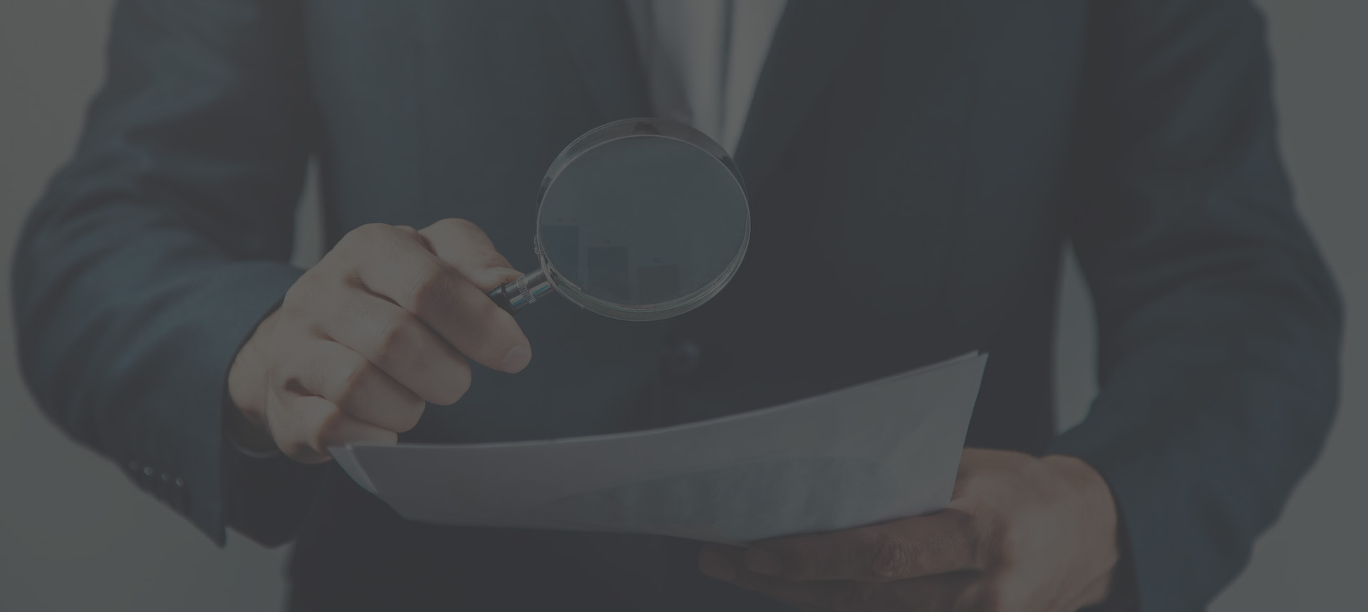 man hand magnifier and document