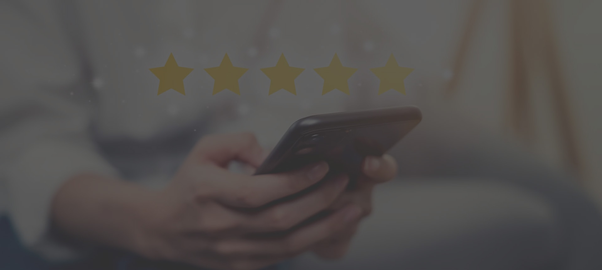 person typing on their phone with stars above it