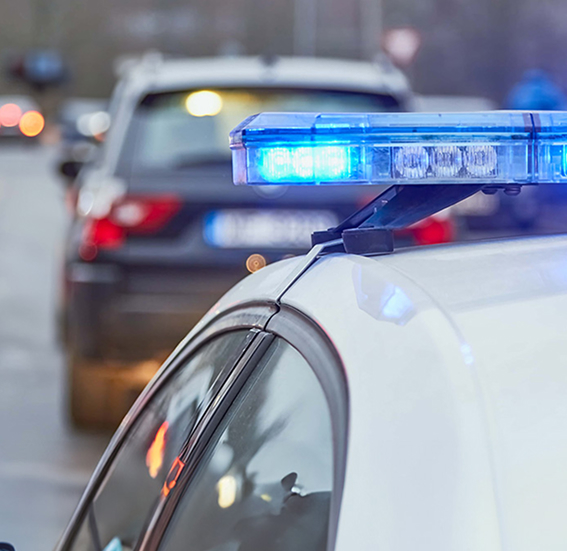 Blue lights of a police car at the scene of an accident