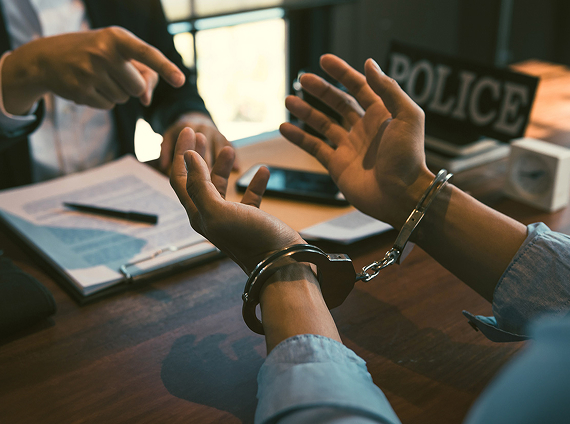 person in handcuffs