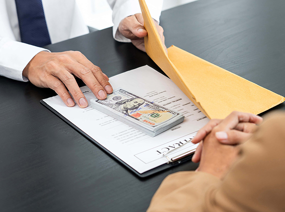 man slipping money into a folder