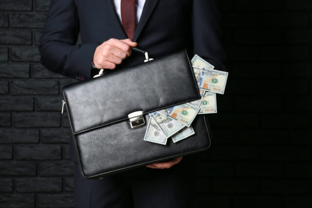 briefcase with money implying embezzlement